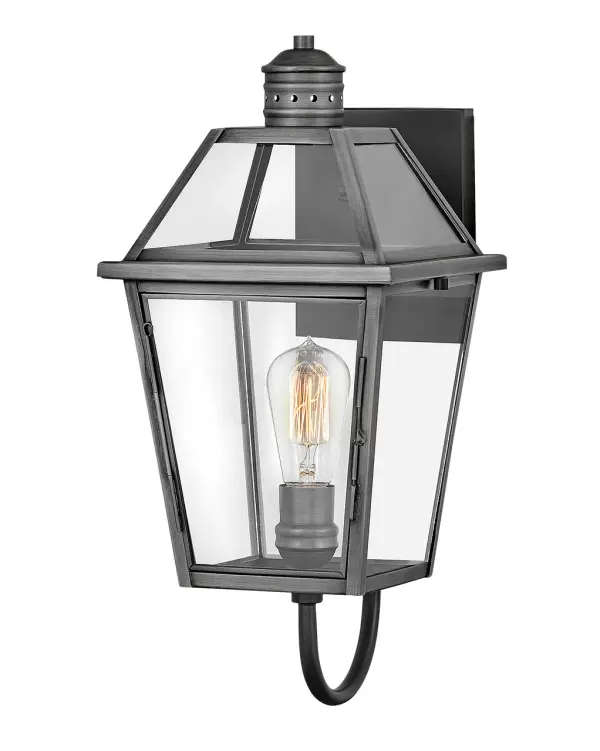 The Nouvelle LED Wall Mount combines solid brass construction with clean, tapered glass panels for a versatile outdoor lighting solution. Its blackened brass finish and wet-rated design make it ideal for exposed exterior locations.