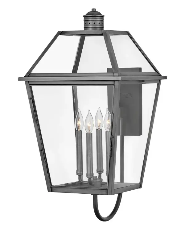The Nouvelle wall mount combines Old World craftsmanship with contemporary LED efficiency. Its solid brass construction and tapered glass panels create a sophisticated presence that enhances both traditional and modern exteriors.