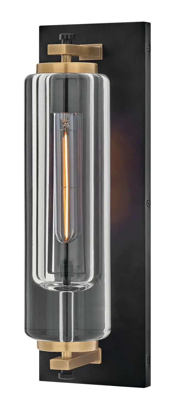 Solid and robust, Lourde’s name says it all. Heavy, layered glass cast in soft cylindrical shapes creates captivating reflections and refractions to illuminate any outdoor or indoor space with a warm glow. The modern, industrial details paired with the Black and Heritage Brass finishes make a bold statement among any aesthetic.