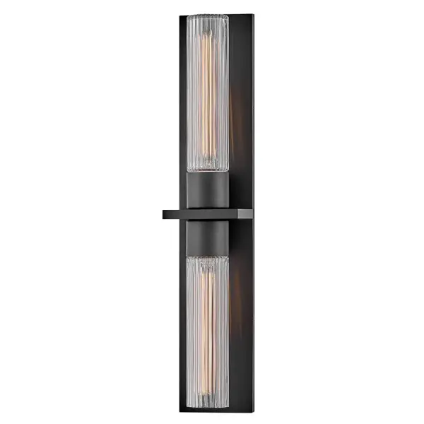 The Voight LED wall sconce combines contemporary design with coastal charm. Its cylindrical profile and ribbed glass create beautiful light diffusion, while weather-resistant composite construction ensures durability in outdoor settings.