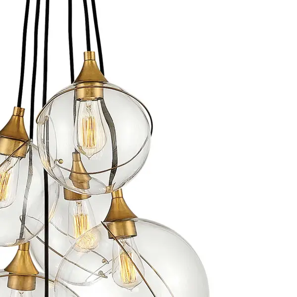 Mesmerizingly asymmetrical with a bohemian, midcentury modern flair, Skye showcases stunning globes of clear or cased opal glass with off-center openings. Slender rings and delicate details in Heritage Brass or Black finishes pull the look together, while adjustable wires allow you to create the perfect look for your space. - alternate view