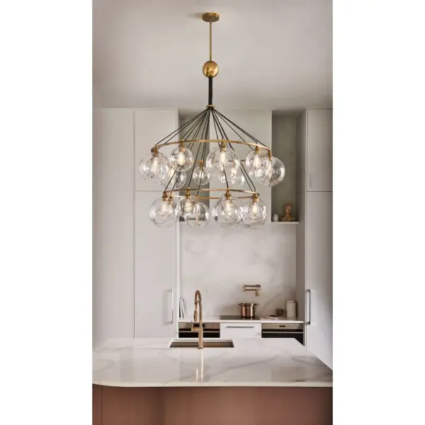 Mesmerizingly asymmetrical with a bohemian, midcentury modern flair, Skye showcases stunning globes of clear or cased opal glass with off-center openings. Slender rings and delicate details in Heritage Brass or Black finishes pull the look together, while adjustable wires allow you to create the perfect look for your space. - alternate view