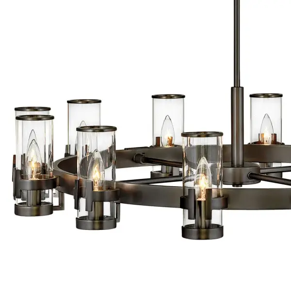 The Reeve chandelier balances sophistication with simplicity. The traditional low-profile silhouette is elevated by a wealth of elegant clear glass cylinders. Each glass is secured with a cast double-T bracelet matching the frame's luxurious finish with a corresponding metal band at the top. - alternate view