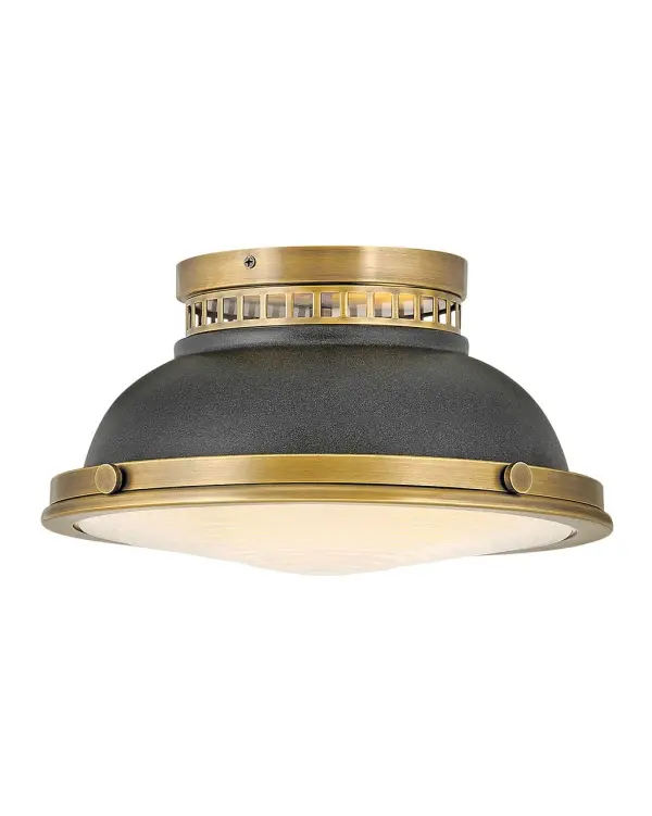 Inspired by vintage industrial lighting, Emery cuts a bold figure layered with unique details and robust finish options that include Polished Antique Nickel, Heritage Brass and Heritage Brass with Aged Zinc. Unique metal cutouts allow illumination to graze the ceiling while a functional down light is enclosed in heavy holophane glass, completing its authentic appearance.