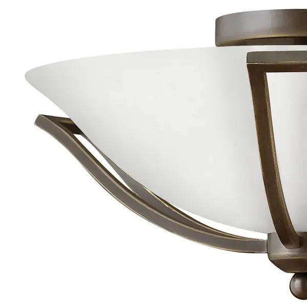 The graceful lines of Bolla’s sweeping double arms create a soft elegance while heavy cast spheres perched at the tips add to its innovative style. The strong proportions of the arms contrast with the subtle bell shaped glass, combining both traditional and modern details. - alternate view