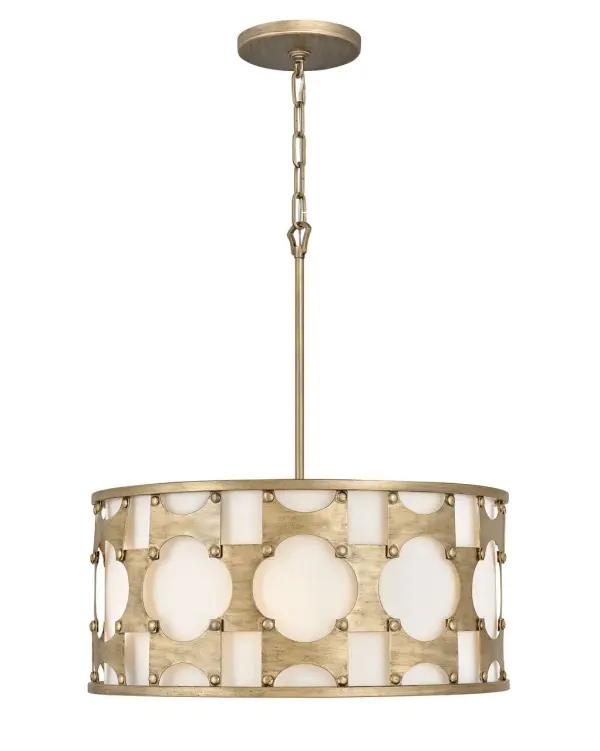 Carter is a traditional drum silhouette with details galore. An intricate, hand-riveted pattern in Burnished Gold encompasses the off-white textured fabric shade. A decorative candle cluster bursts within to further enhance this dynamic design.