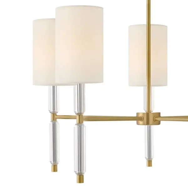The Anika LED Chandelier combines glamorous cinched crystal stems with columnar white shades for a luxuriously sophisticated look. Energy-efficient integrated LED technology provides bright yet soft illumination, while the lacquered brass finish adds warmth and elegance to any space. - alternate view
