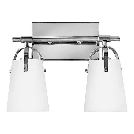 Clean and airy, Foster breathes composed simplicity into any bath space. Softly tapered glass shades suspended from arched handle prongs create a sophisticated transitional silhouette, enhanced by practical yet stylized details.