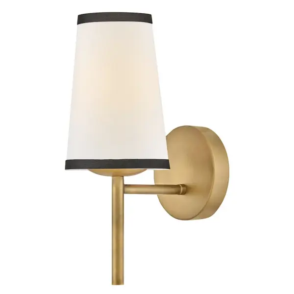 A take on traditional sconce styles, Sonia’s tapered shades feature contrasting top and bottom binding. The chic metal frame and accents are finished in versatile Lacquered Brass to complement any color palette.