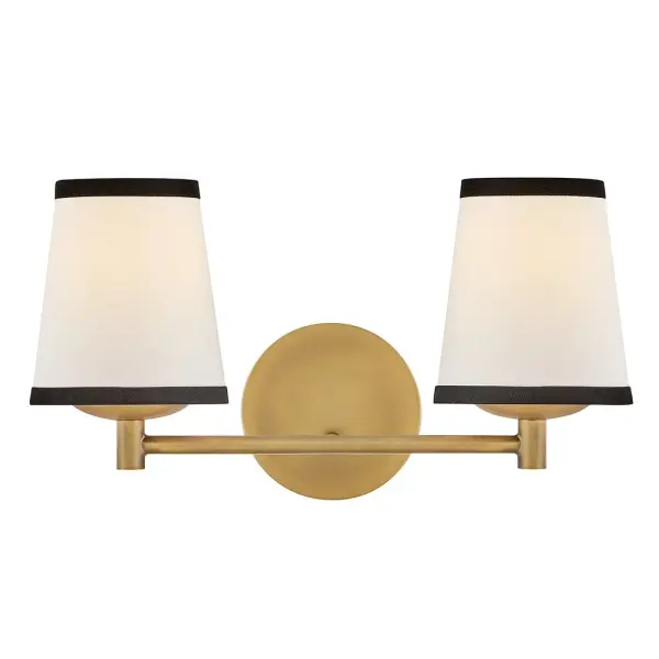 A take on traditional sconce styles, Sonia’s tapered shades feature contrasting top and bottom binding. The chic metal frame and accents are finished in versatile Lacquered Brass to complement any color palette.