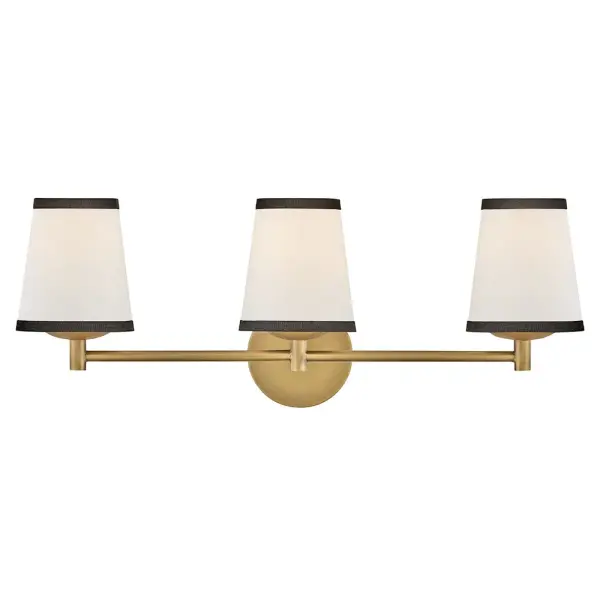 A take on traditional sconce styles, Sonia’s tapered shades feature contrasting top and bottom binding. The chic metal frame and accents are finished in versatile Lacquered Brass to complement any color palette.