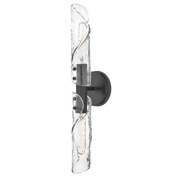 Evoking the movement of flowing water, Capri’s linear, clear glass shades are pressed to create a subtle crystalline texture, then twisted and shaped by hand. Metal backplates and rounded knobs finished in Black or Distressed Brass provide balance that anchors the organic form, resulting in a look that feels both refreshing and refined.