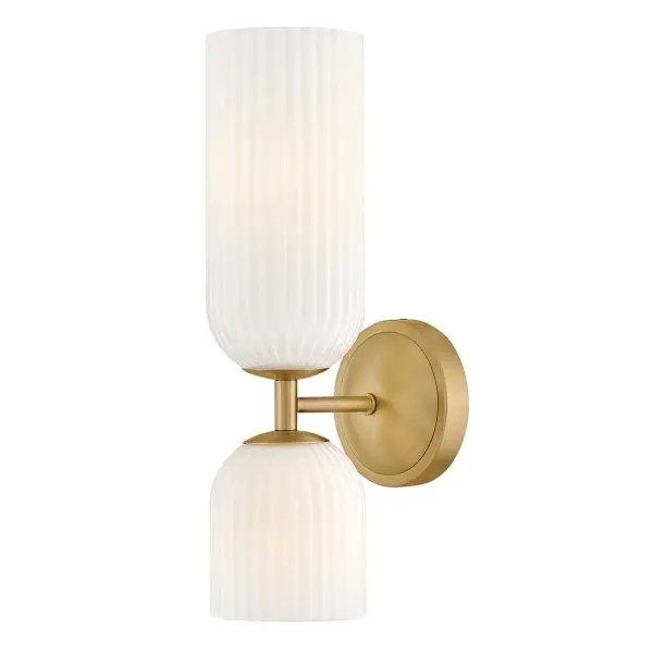 The graceful curves of Ava’s transitional ribbed glass shades are balanced by a sleek silhouette and stepped backplate. A hand-painted Lacquered Brass finish complements the Clear or Cased Opal glass with warm metallic tones, creating a timeless look that complements any décor style.
