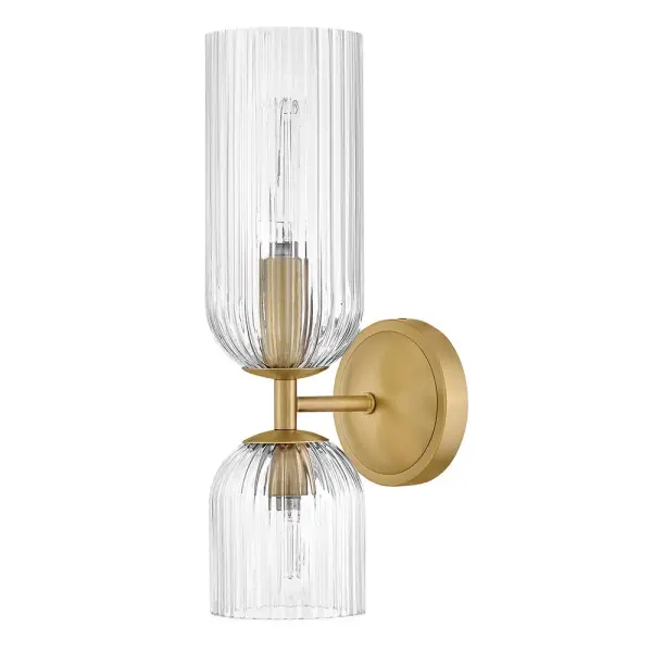 The graceful curves of Ava’s transitional ribbed glass shades are balanced by a sleek silhouette and stepped backplate. A hand-painted Lacquered Brass finish complements the Clear or Cased Opal glass with warm metallic tones, creating a timeless look that complements any décor style. - alternate view
