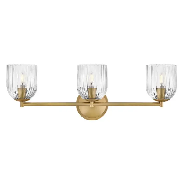 The graceful curves of Ava’s transitional ribbed glass shades are balanced by a sleek silhouette and stepped backplate. A hand-painted Lacquered Brass finish complements the Clear or Cased Opal glass with warm metallic tones, creating a timeless look that complements any décor style.