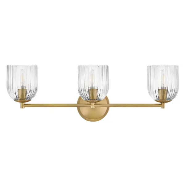 The graceful curves of Ava’s transitional ribbed glass shades are balanced by a sleek silhouette and stepped backplate. A hand-painted Lacquered Brass finish complements the Clear or Cased Opal glass with warm metallic tones, creating a timeless look that complements any décor style. - alternate view