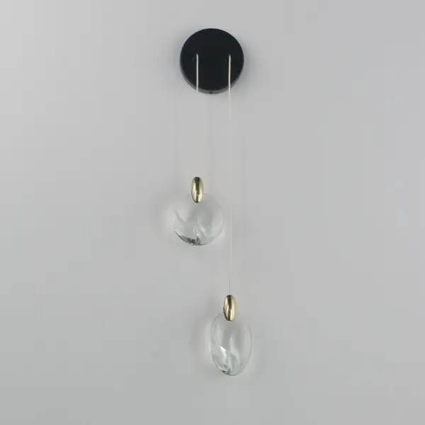 The Pebble Wall Sconce transforms natural riverbed inspiration into sophisticated lighting art. Irregularly shaped crystal pebbles suspended by polished gold clasps create an iridescent shimmer, while concealed LEDs and downlighting deliver both ambient glow and functional illumination. - alternate view