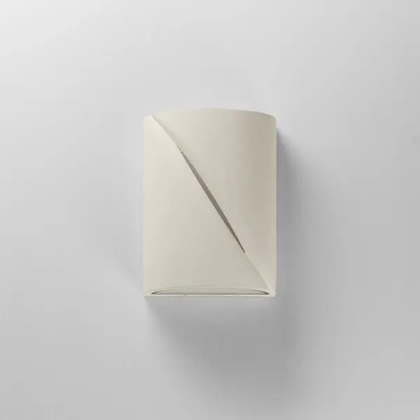 The Puff outdoor wall sconce combines architectural concrete construction with sophisticated LED lighting. Its softly rounded form and diagonal light reveal create ambient illumination while adding contemporary style to exterior spaces. - alternate view