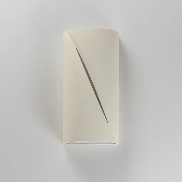 The Puff outdoor wall sconce combines architectural concrete construction with sophisticated lighting design. Its softly rounded form and diagonal reveal create ambient up/down lighting while adding sculptural interest to exterior spaces. - alternate view