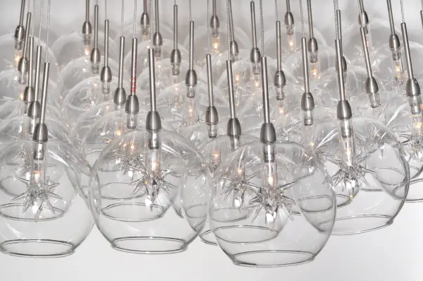 The Starburst pendant transforms any space into a celestial showcase with 37 individual glass globes in vibrant colors. Perfect for grand entryways and dining rooms, this dramatic fixture combines contemporary design with artisanal craftsmanship. - alternate view