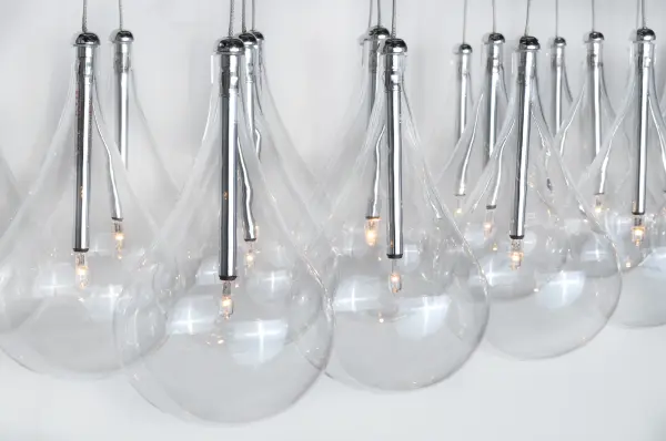 The Larmes collection delivers dramatic visual impact with rows of oversized clear glass teardrops suspended from polished chrome. Each drop is individually adjustable for custom stagger effects and height customization. - alternate view