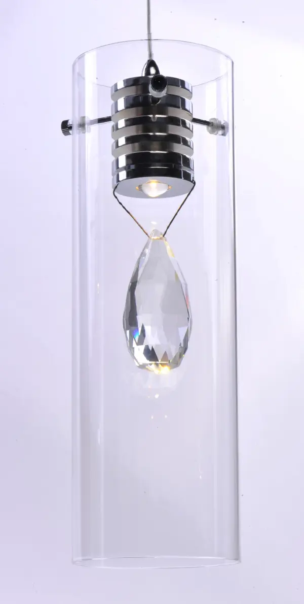 The Solitaire pendant combines timeless crystal elegance with contemporary LED technology. Its beveled crystal almond suspended in clear glass creates stunning light refraction, while the polished chrome finish adds modern sophistication. - alternate view