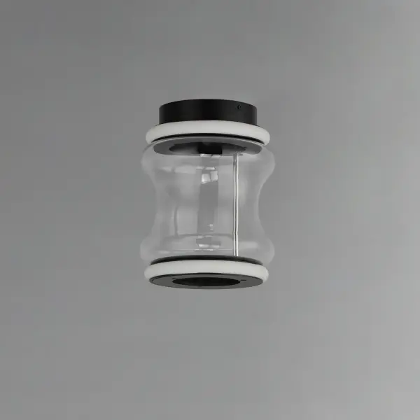 The Syndicate LED Flush Mount combines contemporary industrial style with artisanal craftsmanship. Featuring segmented LED rings and hand-blown hourglass glass shades in Matte Black, it delivers 720 lumens of warm 3000K light. - alternate view