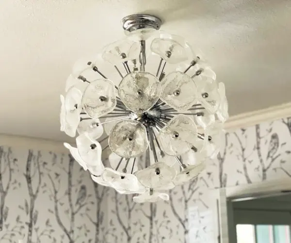 The Fiori pendant combines contemporary design with artisanal Murano glass craftsmanship. Its floral sphere of hand-formed crystal petals creates a dramatic focal point with exceptional light diffusion, perfect for upscale residential and hospitality spaces. - alternate view