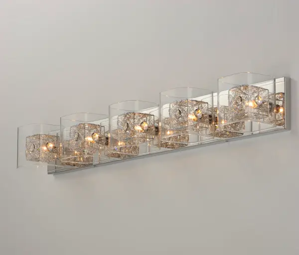The Gem Bath Vanity creates a captivating visual with intertwined metal cubes encased in clear crystal, producing a floating illusion. With 5 lights delivering 4000 lumens, it provides excellent illumination while serving as a striking focal point. - alternate view