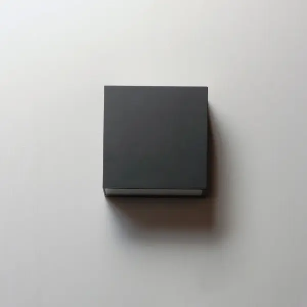 The Blok sconce delivers 960 lumens of warm LED light in a minimalist cube design. ADA-compliant with minimal wall extension, it's ideal for corridors, entryways, and hospitality applications with IP-rated durability. - alternate view