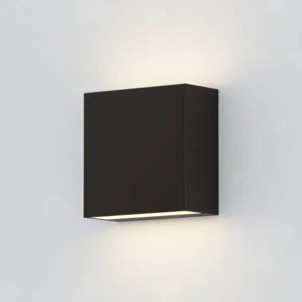 This minimalist outdoor sconce combines clean geometric design with practical functionality. Features adjustable beam angles for customized lighting, ADA-compliant dimensions, and energy-efficient LED technology in a durable aluminum housing. - alternate view