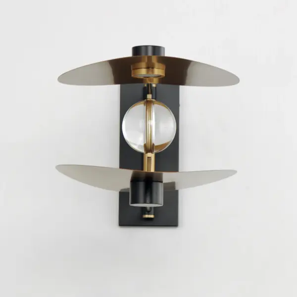 The Pearl sconce combines artistic design with practical functionality, featuring crystal orbs behind curved brass shades. Rotating LED housings offer versatile lighting options—upward for ambient glow or downward for task lighting. Individual switches make it ideal for bedside use. - alternate view
