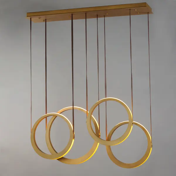 The Tether pendant combines industrial materials with refined design, featuring tapered brass rings suspended by leather straps. Concealed LEDs create dramatic indirect lighting that illuminates neighboring rings and spaces above and below. - alternate view