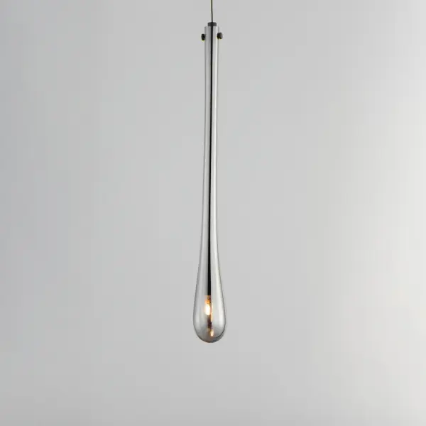 The Stillo Mini Pendant features luxurious hand-blown glass in an elongated teardrop form with a slender LED socket suspended within. The matte black finish paired with mirror smoked glass creates a moody, contemporary aesthetic perfect for intimate spaces. - alternate view