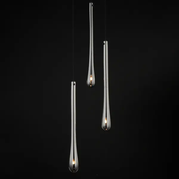The Stillo combines artisanal hand-blown glass with contemporary design, featuring elongated teardrop shades in Mirror Smoked glass paired with Matte Black metalwork. Energy-efficient LED lighting creates ambient illumination perfect for intimate spaces. - alternate view