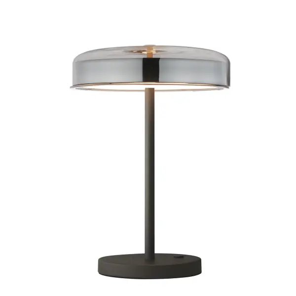The Voto LED Table Lamp features innovative edge-lit technology within shallow glass domes, creating a striking visual effect while delivering efficient, evenly distributed illumination. Its minimalist gunmetal frame conceals all hardware for a clean, contemporary aesthetic.