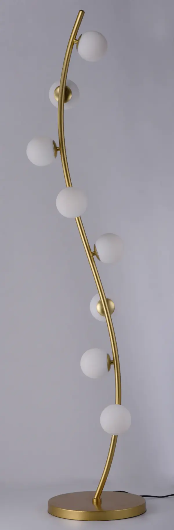 The Rover Floor Lamp brings nature-inspired elegance indoors with its curved metallic gold stem adorned with satin white glass globes. Integrated LED technology provides warm, energy-efficient lighting perfect for modern living spaces. - alternate view