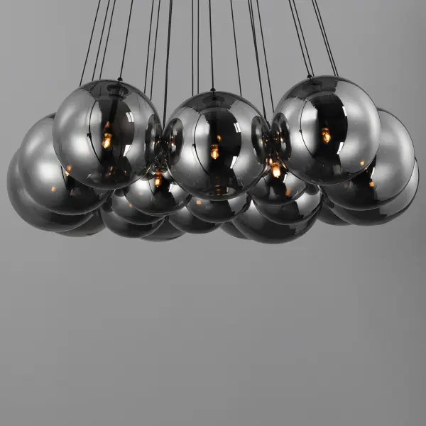 The Burst pendant creates a stunning focal point with 20 LED-lit smoked glass globes radiating from a central point. Matte black frame and cables provide bold contrast while energy-efficient G4 LEDs deliver warm illumination. - alternate view