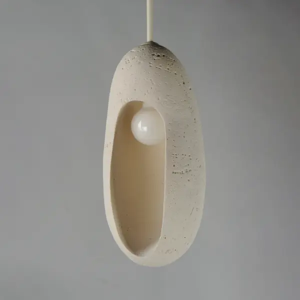 The Luna Elongated LED Pendant combines industrial concrete with contemporary design. Its warm 3000K LED provides ambient lighting perfect for intimate spaces. The chalk white finish softens the concrete aesthetic. - alternate view