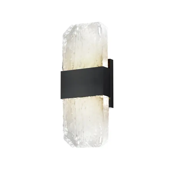 The Rune Small Sconce combines handcrafted artisanal glass with modern LED technology, creating a sophisticated outdoor lighting solution. Its cast glass slabs showcase unique imperfections while concealed LEDs provide warm, efficient illumination.