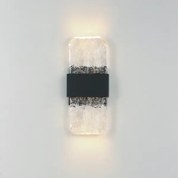The Rune Small Sconce combines handcrafted artisanal glass with modern LED technology, creating a sophisticated outdoor lighting solution. Its cast glass slabs showcase unique imperfections while concealed LEDs provide warm, efficient illumination. - alternate view
