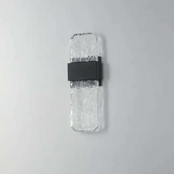 The Rune outdoor wall sconce showcases handcrafted cast glass slabs with unique imperfections, elevated by concealed LED lighting. Its durable aluminum construction and weather-resistant black finish make it ideal for exterior applications. - alternate view