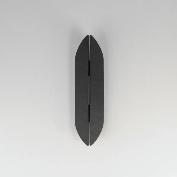 The Tectonic sconce combines architectural drama with functional outdoor lighting. Its textured panels create an enigmatic split design that casts soft ambient light up, down, and through the center crevice. The matte black exterior with antique brass interior adds warmth to modern and contemporary outdoor spaces. - alternate view