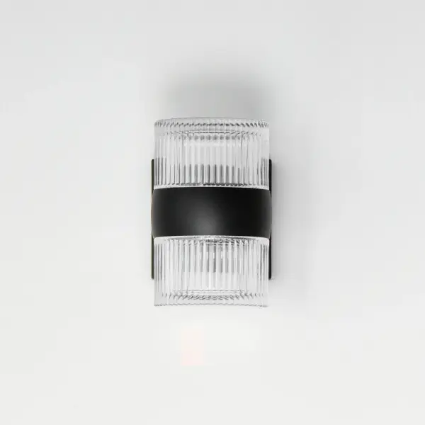 The Modular LED wall sconce combines minimalist design with functional outdoor lighting. Its streamlined aluminum construction and customizable glass lens options deliver 1040 lumens of warm 3000K light while meeting Dark Sky compliance standards. - alternate view