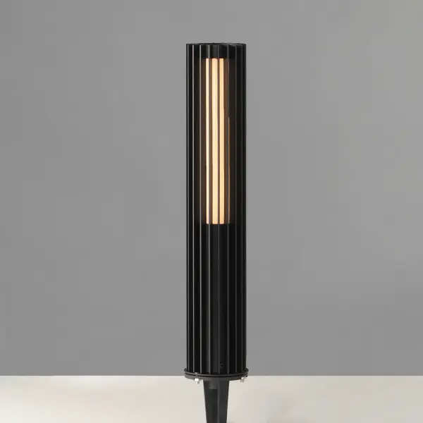 The Citadel pathway light features a sleek contemporary design with vertical aluminum strands surrounding an LED tube. Its slim 4-inch profile makes it ADA compliant while providing 450 lumens of warm 3000K light. - alternate view