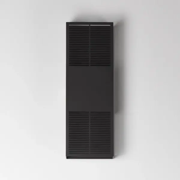 The Grate outdoor wall sconce transforms simple geometry into stunning visual drama. Precision-cut slits cast intricate light patterns across surrounding surfaces, while energy-efficient LED technology delivers warm 3000K illumination. - alternate view