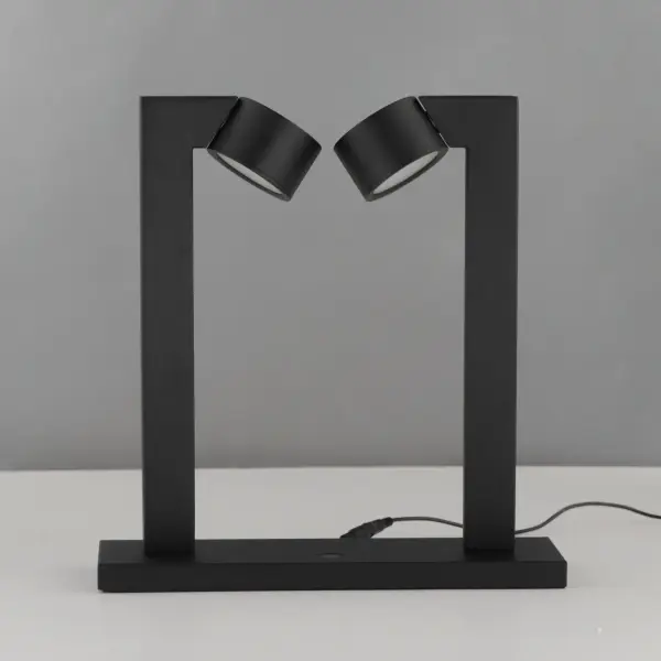 The Embrace desk lamp features a distinctive modern design with two circular LED modules that rotate independently for precise light direction. Its matte black steel frame and integrated touch dimming make it ideal for task lighting. - alternate view
