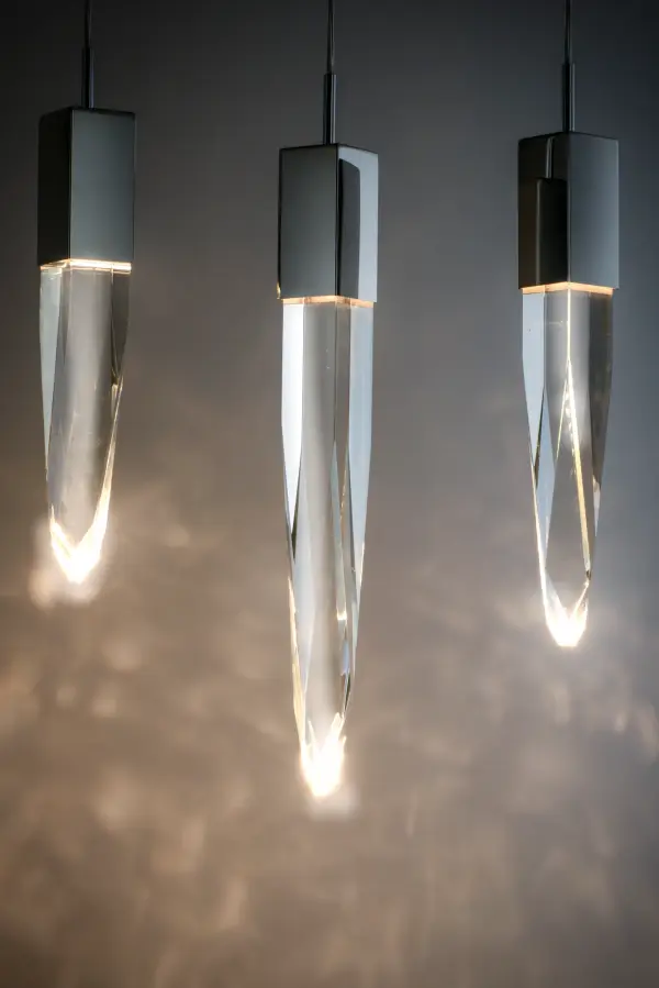 The Quartz pendant transforms spaces with its spectacular array of beveled crystal stalactites suspended at varying heights. High-CRI LED modules illuminate the faceted crystals, creating mesmerizing light diffusion and sparkle. - alternate view
