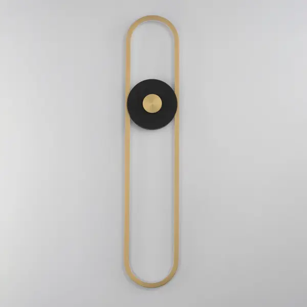 The Gravity X-Large sconce combines contemporary style with practical outdoor performance. Its striking elliptical gold element contrasts beautifully against a black disc, while corrosion-resistant aluminum and UV-rated finishes ensure lasting durability in wet locations. - alternate view