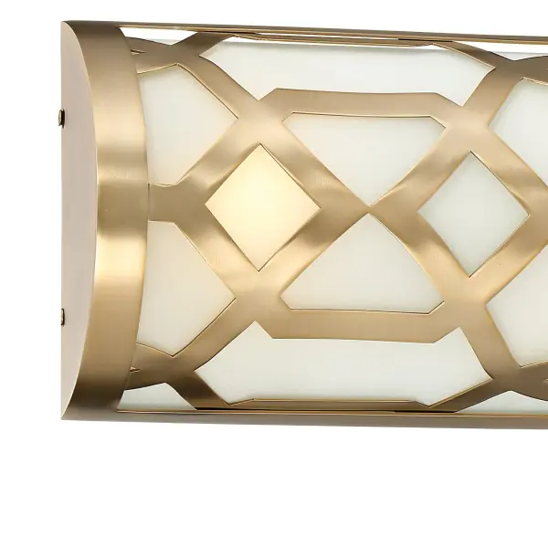 The Jennings vanity light combines classic elegance with modern geometric design. Its open metal framework in aged brass paired with white glass shades creates a sophisticated look perfect for transitional bathrooms. ADA-compliant and energy-efficient LED technology. - alternate view